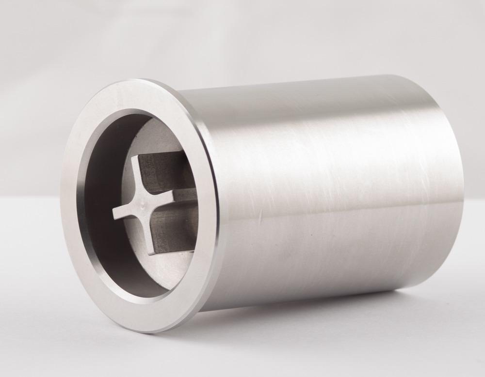 AquaVolt water efficiency device shown at an angle — commercial-grade stainless steel cylinder with the internal flow geometry visible through the opening